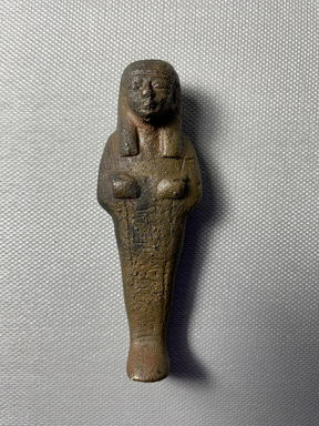  <em>Small Shawabti</em>. Bronze, 3 7/16 x 1 3/16 x 13/16 in. (8.8 x 3 x 2.1 cm). Brooklyn Museum, Gift of Albert Gallatin, 61.129. Creative Commons-BY (Photo: Brooklyn Museum, CUR.61.129_view01.jpg)