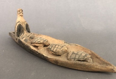 Karaja. <em>Seated Figurine in Canoe with Three Turtles</em>, ca. mid 20th century. Ceramic, pigment, 9 5/8 x 3 3/16 x 2 9/16 in. (24.4 x 8.1 x 6.5 cm). Brooklyn Museum, Gift of Ingeborg de Beausacq, 62.180.18. Creative Commons-BY (Photo: Brooklyn Museum, CUR.62.180.18_view01.jpg)