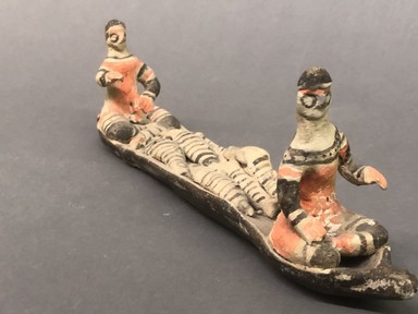  <em>Canoe with Two Seated Figures</em>, ca. mid-20th century. Ceramic, pigment, 11 7/16 x 2 3/8 x 3 9/16 in. (29.0 x 6.0 x 9.0 cm). Brooklyn Museum, Gift of Ingeborg de Beausacq, 62.180.27. Creative Commons-BY (Photo: Brooklyn Museum, CUR.62.180.27_view01.jpg)