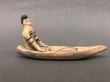 Karaja. <em>Figurine Seated in Canoe with Fish</em>, ca. mid-20th century. Ceramic, pigment, 8 x 2 1/4 x 4 1/4 in. (20.3 x 5.7 x 10.8 cm). Brooklyn Museum, Gift of Ingeborg de Beausacq, 62.180.28. Creative Commons-BY (Photo: Brooklyn Museum, CUR.62.180.28_view01.jpg)