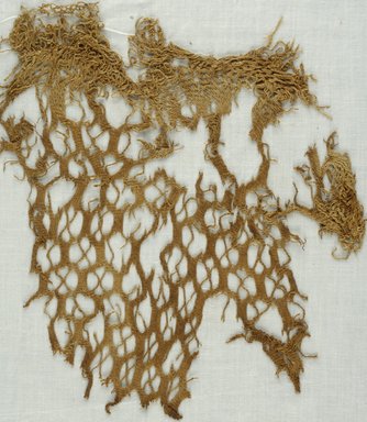 Coptic. <em>Netted Weave Fragment</em>, 5th-7th century C.E. Plant fiber, 10 1/2 x 10 3/4 in. (26.7 x 27.3 cm). Brooklyn Museum, Gift of Adelaide Goan, 64.114.243 (Photo: Brooklyn Museum (in collaboration with Index of Christian Art, Princeton University), CUR.64.114.243_ICA.jpg)