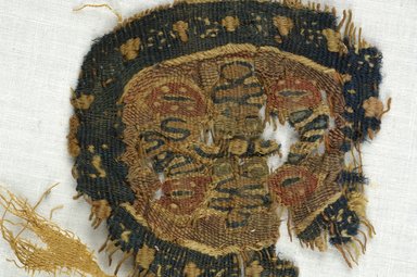 Coptic. <em>Roundel Fragment with Botanical Decoration</em>, 5th-7th century C.E. Wool, 3 1/8 x 3 1/8 in. (8 x 8 cm). Brooklyn Museum, Gift of Adelaide Goan, 64.114.277 (Photo: Brooklyn Museum (in collaboration with Index of Christian Art, Princeton University), CUR.64.114.277_detail01_ICA.jpg)