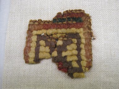 Wari (?). <em>Textile Fragment, Undetermined (NK) or Hat, Fragment or Headband, Fragment (AR)</em>, 1400-1532 or 600-1000. Cotton, camelid fiber, 1 15/16 x 1 3/4 in. (5.0 x 4.5 cm). Brooklyn Museum, Gift of Adelaide Goan, 64.114.61 (Photo: , CUR.64.114.61_view01.jpg)
