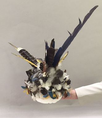 Karaja. <em>Headdress</em>, 20th century. Feathers (brown, white, blue, yellow), plant fibers, 11 1/4 × 23 × 13 1/2 in. (28.6 × 58.4 × 34.3 cm), on storage support. Brooklyn Museum, A. Augustus Healy Fund, 64.214.1. Creative Commons-BY (Photo: Brooklyn Museum, CUR.64.214.1_view01-1.jpg)