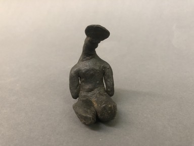 Karaja (?). <em>Seated Figure with Headdress</em>, 20th century. Resin, 2 1/4 × 1 1/4 × 1 1/2 in. (5.7 × 3.2 × 3.8 cm). Brooklyn Museum, A. Augustus Healy Fund, 64.214.55. Creative Commons-BY (Photo: Brooklyn Museum, CUR.64.214.55_view01.jpg)
