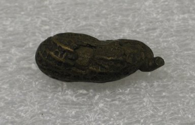 Akan. <em>Gold-weight (abrammuo): peanut</em>. Brass, 1/2 x 1 1/4 in. (1.3 x 3.2 cm). Brooklyn Museum, Bequest of Laura L. Barnes, 67.25.27. Creative Commons-BY (Photo: Brooklyn Museum, CUR.67.25.27_side1.jpg)