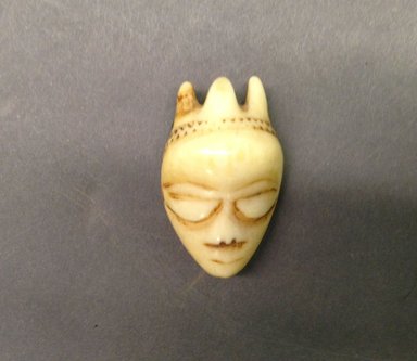 Pende (Central). <em>Pendant (Ghikhokho) with Chieftain's Headdress</em>, 19th century. Ivory, 2 x 1 1/8 x 5/8 in. (4.7 x 3.1 x 1.7 cm). Brooklyn Museum, Bequest of Laura L. Barnes, 67.25.28. Creative Commons-BY (Photo: Brooklyn Museum, CUR.67.25.28.jpg)