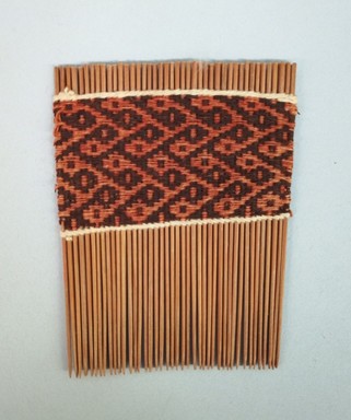  <em>Comb</em>, 20th century. Wood, cotton, 2 7/8 × 3 11/16 × 1/8 in. (7.3 × 9.4 × 0.3 cm). Brooklyn Museum, Bequest of Laura L. Barnes, 67.25.42. Creative Commons-BY (Photo: Brooklyn Museum, CUR.67.25.42.jpg)