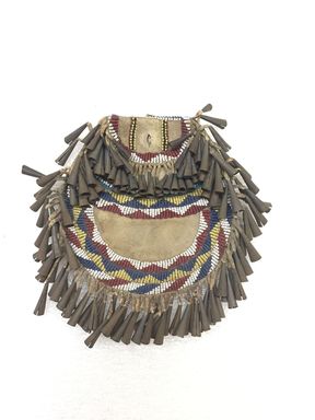 Apache. <em>Round Beaded Pouch with Bugle Beads</em>, ca. 1890. Hide, beads, metal, 6 3/8 × 6 5/8 × 1 in. (16.2 × 16.8 × 2.5 cm). Brooklyn Museum, Gift of J.L. Greason, 67.26.16. Creative Commons-BY (Photo: Brooklyn Museum, CUR.67.26.16_view01.jpg)