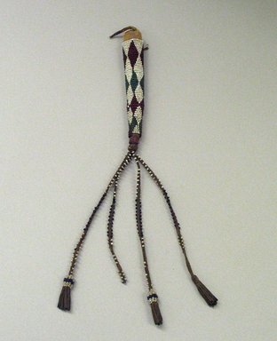 Possibly Sioux or. <em>Awl Case</em>, 1898-1902. Hide, beads, metal, sinew, 11 x 5 15/16 in. (27.9 x 15.1 cm). Brooklyn Museum, Gift of J.L. Greason, 67.26.17a-b. Creative Commons-BY (Photo: Brooklyn Museum, CUR.67.26.17_view1.jpg)
