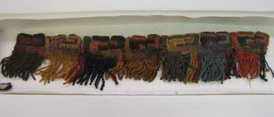 Nasca (attributed by Nobuko Kajatani, 1993). <em>Mantle, Fragment or Poncho, Fragment (NK) or Mantle?, Border, Fragment (AR)</em>, 200-600 C.E. Camelid fiber, 2 × 9 1/2 × 1/8 in. (5.1 × 24.1 × 0.3 cm). Brooklyn Museum, Gift of Jack Lenor Larsen, 68.217.3. Creative Commons-BY (Photo: , CUR.68.217.3.jpg)