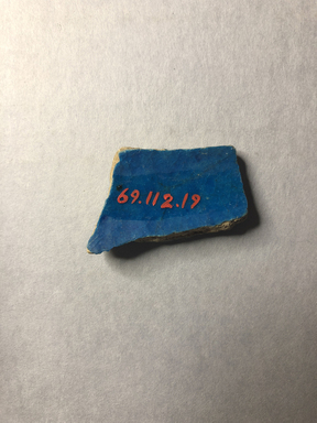  <em>Vessel Fragment</em>, 305 B.C.E.-395 C.E. Faience, 1 3/4 x 1 x 1/4 in. (4.5 x 2.5 x 0.7 cm). Brooklyn Museum, Anonymous gift, 69.112.19. Creative Commons-BY (Photo: , CUR.69.112.19_view02.jpg)