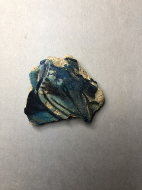  <em>Vessel Fragment</em>, 305 B.C.E.–395 C.E. Faience, 2 3/16 x 2 3/8 x 1/4 in. (5.5 x 6 x 0.7 cm). Brooklyn Museum, Anonymous gift, 69.112.1. Creative Commons-BY (Photo: , CUR.69.112.1_view01.jpg)
