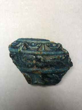  <em>Vessel Fragment</em>, 305 B.C.E.–395 C.E. Faience, 2 3/8 x 2 3/4 x 1/2 in. (6 x 7 x 1.2 cm). Brooklyn Museum, Anonymous gift, 69.112.20. Creative Commons-BY (Photo: , CUR.69.112.20_view01.jpg)