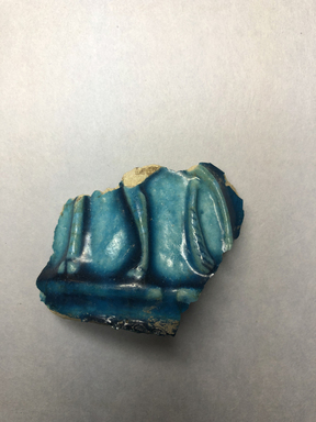  <em>Vessel Fragment</em>, 305 B.C.E.–395 C.E. Faience, 1 15/16 x 2 3/16 x 2 5/8 in. (5 x 5.5 x 6.7 cm). Brooklyn Museum, Anonymous gift, 69.112.30. Creative Commons-BY (Photo: , CUR.69.112.30_view01.jpg)