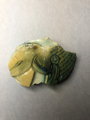  <em>Vessel Fragment</em>, 305 B.C.E.–395 C.E. Faience, 1 15/16 x 2 3/4 in. (5 x 7 cm). Brooklyn Museum, Anonymous gift, 69.112.31. Creative Commons-BY (Photo: , CUR.69.112.31_view01.jpg)