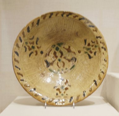  <em>Bowl with Arabic Inscription in Thuluth Script</em>, mid-14th century. Ceramic; earthenware, with incised decoration through a white slip and painted with brown and green pigments under a transparent amber glaze, 4 3/4 x 13 1/16 in. (12 x 33.2 cm). Brooklyn Museum, Henry L. Batterman Fund, A. Augustus Healy Fund, Frank Sherman Benson Fund and Ella C. Woodward Memorial Fund, 69.122.2. Creative Commons-BY (Photo: Brooklyn Museum, CUR.69.122.2.jpg)