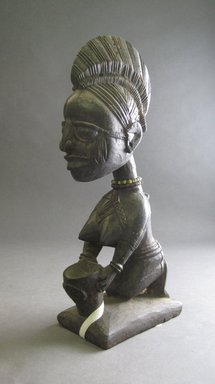 Yorùbá. <em>Kneeling Female Figure Holding Bowl</em>, late 19th or early 20th century. Wood, pigment, h: 10 3/4 in. (27.0 cm). Brooklyn Museum, Gift of Dr. and Mrs. Abbott A. Lippman, 71.177.3. Creative Commons-BY (Photo: Brooklyn Museum, CUR.71.177.3_overall.jpg)
