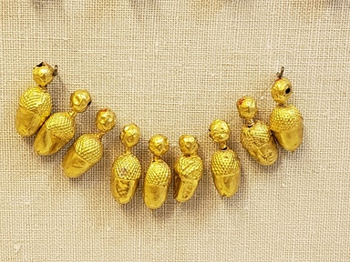 Greek. <em>Acorn</em>, late 4th century B.C.E. Gold, 1 x 3/8 in. (2.6 x 1 cm). Brooklyn Museum, Gift of Mr. and Mrs. Thomas S. Brush, 71.79.7. Creative Commons-BY (Photo: Brooklyn Museum, CUR.71.79.1-.9_overall.jpg)