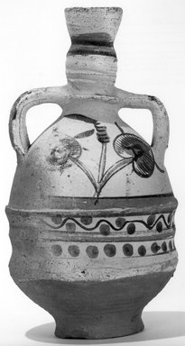  <em>Amphora</em>, 3rd-4th century C.E. Clay, slip, 11 13/16 x Diam. 6 1/8 in. (30 x 15.5 cm). Brooklyn Museum, Charles Edwin Wilbour Fund, 71.86. Creative Commons-BY (Photo: Brooklyn Museum, CUR.71.86_NegB_print_bw.jpg)