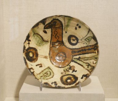  <em>Bowl with a Bird</em>, 10th-11th century. Ceramic, Sari ware; earthenware, painted in red, brown, and green slip on a white slip ground under a transparent glaze, 3/8 x 2 7/8 in. (1 x 7.3 cm). Brooklyn Museum, Gift of The Roebling Society, 73.30.2. Creative Commons-BY (Photo: Brooklyn Museum, CUR.73.30.2.jpg)