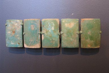  <em>Wall Tile from a Royal Funerary Structure</em>, ca. 2675–2625 B.C.E. Faience, 2 3/16 x 1 7/16 x 11/16 in. (5.6 x 3.6 x 1.8 cm). Brooklyn Museum, Charles Edwin Wilbour Fund, 73.84.2. Creative Commons-BY (Photo: , CUR.73.84.1_34.1180c-d_73.84.2_34.1180a_erg2.jpg)