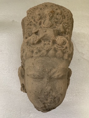  <em>Head of a Male Deity</em>, 11th century. Sandstone, 15 in. (38.1 cm). Brooklyn Museum, Gift of Nathan Hammer, 74.61.9. Creative Commons-BY (Photo: Brooklyn Museum, CUR.74.61.9_front.jpg)