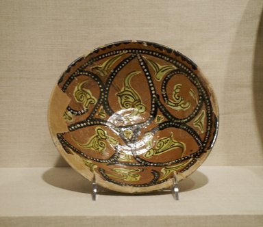  <em>Bowl with Abstract Foliate Design</em>, 10th century. Ceramic; earthenware, painted in black, yellow, and white slip on a red slip ground under a transparent glaze, 2 1/2 x 8 1/4 in. (6.3 x 21 cm). Brooklyn Museum, Gift of Mr. and Mrs. Charles K. Wilkinson, 75.117.1. Creative Commons-BY (Photo: Brooklyn Museum, CUR.75.117.1.jpg)