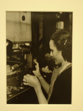 Lewis Wickes Hine (American, 1874-1940). <em>[Untitled] (Woman with Small Metal Forms)</em>, 1936-1937. Gelatin silver photograph, 7 1/4 x 4 3/4 in.  (18.4 x 12.1 cm). Brooklyn Museum, Gift of the National Archives, 79.143.52 (Photo: Brooklyn Museum, CUR.79.143.52.jpg)