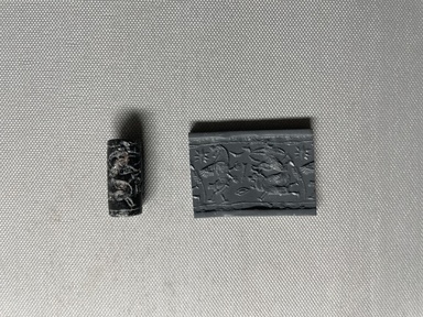 Ancient Near Eastern. <em>Cylinder Seal</em>, 9th-8th century B.C.E. Hematite (?), 1 1/4 x Diam. 9/16 in. (3.2 x 1.5 cm). Brooklyn Museum, Gift of Mr. and Mrs. Carl L. Selden, 80.173.3. Creative Commons-BY (Photo: Brooklyn Museum, CUR.80.173.3_overall01.jpeg)