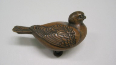  <em>Netsuke depicting Pigeon, with unusual handling of Himotoshi</em>, early 19th century. Boxwood, 1 7/8 x 2 13/16 in. (4.8 x 7.2 cm). Brooklyn Museum, Anonymous gift, 80.255.18. Creative Commons-BY (Photo: , CUR.80.255.18.jpg)