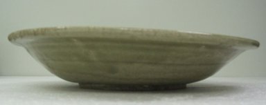  <em>Plate</em>, 16th century. Stoneware with olive-green glaze, 2 1/4 x 12 1/2 in. (5.7 x 31.8 cm). Brooklyn Museum, Gift of Dr. Jerome Krieger, 80.270.4. Creative Commons-BY (Photo: Brooklyn Museum, CUR.80.270.4_side.jpg)