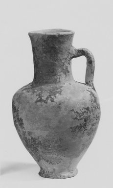  <em>Small Jug</em>, 305-30 B.C.E. Clay, slip, 5 1/8 x 2 15/16 in. (13 x 7.4 cm). Brooklyn Museum, Gift of the Egyptian Antiquities Organization, 80.7.11. Creative Commons-BY (Photo: Brooklyn Museum, CUR.80.7.11_NegA_print_bw.jpg)