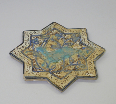 <em>Eight-Pointed Star Tile with a Gazelle</em>, 13th-14th century. Ceramic; fritware, painted in luster and blue over an opaque white glaze, 8 1/4 x 3/8 x 8 1/4 in. (21 x 1 x 21 cm). Brooklyn Museum, Gift of the Ernest Erickson Foundation, Inc., 86.227.71. Creative Commons-BY (Photo: Brooklyn Museum, CUR.86.227.71_view1.jpg)