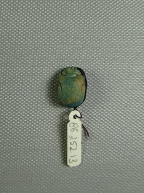  <em>Scarab</em>, ca. 1539–1075 B.C.E. Faience, 1/2 x 1/4 x 11/16 in. (1.2 x 0.7 x 1.7 cm). Brooklyn Museum, Gift of Jerome A. and Mary Jane Straka, 86.252.13. Creative Commons-BY (Photo: Brooklyn Museum, CUR.86.252.13_view1.jpg)