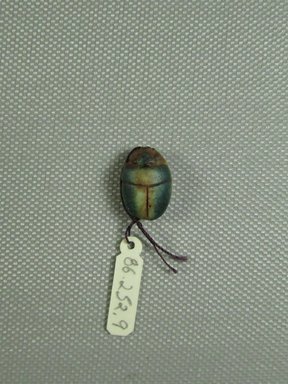 <em>Scarab</em>, ca. 1479-1425 B.C.E. Steatite, glaze, 1/2 x 1/4 x 11/16 in. (1.2 x 0.7 x 1.7 cm). Brooklyn Museum, Gift of Jerome A. and Mary Jane Straka, 86.252.9. Creative Commons-BY (Photo: Brooklyn Museum, CUR.86.252.9_view1.jpg)