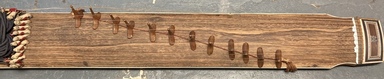  <em>Stringed Instrument (Gayageum)</em>, early 20th century. Wood, cow bone, mother-of-pearl, cloth, 57 1/16 × 8 11/16 × 2 3/4 in. (145.0 × 22.0 × 7.0 cm). Brooklyn Museum, Gift of the Carroll Family Collection, 2020.18.17 (Photo: Image courtesy of The Honorable Joseph P. Carroll and Professor Roberta L. Carroll, M.D., CUR.TL2020.25.15.jpg)