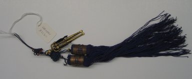  <em>Tassel (Norigae) with Scarecrow Decorations</em>, 20th century. Gilt bronze, metallic thread, string, 12 5/8 x 1 3/8 in. (32 x 3.5 cm). Brooklyn Museum, Brooklyn Museum Collection, X1164. Creative Commons-BY (Photo: Brooklyn Museum, CUR.X1164.jpg)