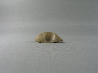  <em>Left Eye Without Pupil from Anthropoid Coffin</em>. Egyptian alabaster (calcite), 9/16 x 1 3/4 x 11/16 in. (1.5 x 4.4 x 1.7 cm). Brooklyn Museum, Brooklyn Museum Collection, X1203.1 (Photo: Brooklyn Museum, CUR.X1203.1_view1.jpg)