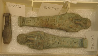  <em>Gray Ushabti</em>, 664-332 B.C.E. Faience, 1 15/16 x 9/16 x 3/8 in. (5 x 1.5 x 1 cm). Brooklyn Museum, Brooklyn Museum Collection, X249.16. Creative Commons-BY (Photo: , CUR.X249.16_37.174E_37.175E.jpg)