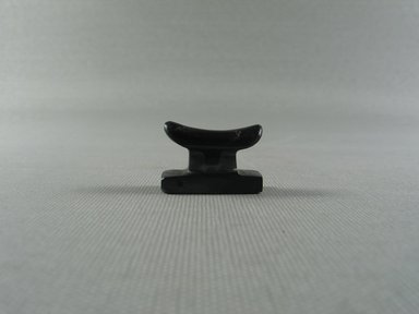  <em>Headrest Amulet</em>. Hematite, 3/4 × 7/16 × 1 1/8 in. (1.9 × 1.1 × 2.8 cm). Brooklyn Museum, Brooklyn Museum Collection, X249.36. Creative Commons-BY (Photo: , CUR.X249.36_view01.jpg)