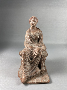  <em>Seated Figure of Woman with Fillet, Tanagra Style</em>. Terracotta, pigment, 6 1/2 × 3 9/16 × 4 1/8 in. (16.5 × 9 × 10.5 cm). Brooklyn Museum, Brooklyn Museum Collection, X249.75. Creative Commons-BY (Photo: Brooklyn Museum, CUR.X249.75_view01.jpeg)
