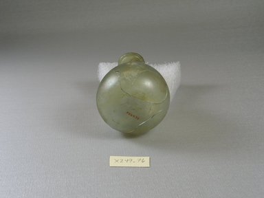 Roman. <em>Bottle</em>, 1st–2nd century C.E. or 4–6th century C.E. Glass, 3 3/8 x 2 5/16 in. (8.5 x 5.9 cm). Brooklyn Museum, Brooklyn Museum Collection, X249.76. Creative Commons-BY (Photo: Brooklyn Museum, CUR.X249.76_bottom.jpg)
