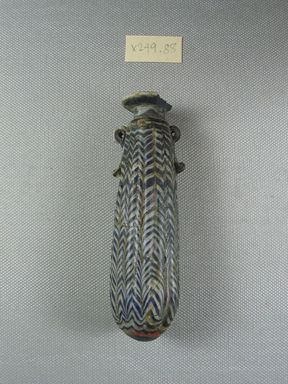  <em>Cylindrical Alabastron</em>, late 6th–early 4th century B.C.E. Glass, 1 5/16 x 1 5/16 x 4 3/8 in. (3.3 x 3.3 x 11.1 cm). Brooklyn Museum, Brooklyn Museum Collection, X249.88. Creative Commons-BY (Photo: Brooklyn Museum, CUR.X249.88_side.jpg)