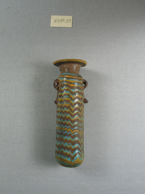  <em>Cylindrical Alabastron</em>, late 6th century–early 4th century B.C.E. Glass, Diam. at top 1 1/4 x 3 15/16 in. (3.1 x 10 cm). Brooklyn Museum, Brooklyn Museum Collection, X249.89. Creative Commons-BY (Photo: Brooklyn Museum, CUR.X249.89_side.jpg)