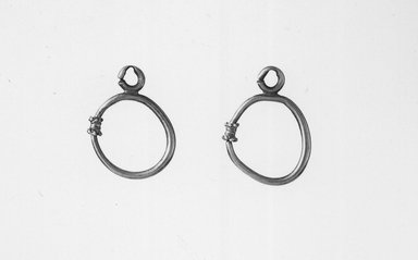  <em>Pair Loop Earrings</em>, 6th-7th century C.E. Gold, 11/16 x 1 in. (1.7 x 2.5 cm). Brooklyn Museum, Brooklyn Museum Collection, X4.1-.2. Creative Commons-BY (Photo: Brooklyn Museum, CUR.X4.1-.2_negA_bw.jpg)
