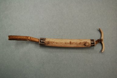 Eskimo. <em>Tubular Needle Case with incised decorations</em>, late 19th-early 20th century. Ivory, hide, 4 1/2 x 1/2 x 1 3/4 in. or (11.5 cm). Brooklyn Museum, Brooklyn Museum Collection, X705.2. Creative Commons-BY (Photo: Brooklyn Museum, CUR.X705.2.jpg)