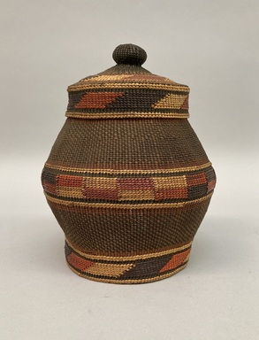 Tlingit. <em>Twined Jar Shaped Basket with False Embroidery with lid</em>, early 20th century. Spruce root, grass, dye, base: 8 1/2 × 4 in. (21.6 × 10.2 cm). Brooklyn Museum, Brooklyn Museum Collection, X854.13a-b. Creative Commons-BY (Photo: Brooklyn Museum, CUR.X854.13a-b.jpg)