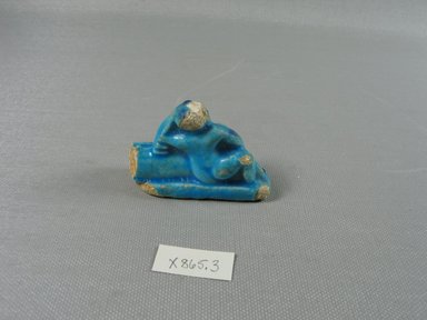  <em>One Figure of a Male</em>, 305-30 B.C.E. Faience, 1 9/16 x 2 3/8 x 13/16 in. (4 x 6.1 x 2.1 cm). Brooklyn Museum, Brooklyn Museum Collection, X865.3. Creative Commons-BY (Photo: Brooklyn Museum, CUR.X865.3_back.jpg)