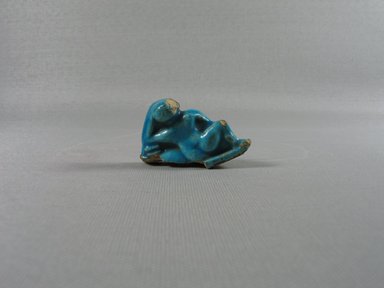  <em>One Erotic Figure of a Male</em>, 305-30 B.C.E. Faience, 1 7/16 x 2 1/8 x 3/4 in. (3.7 x 5.4 x 1.9 cm). Brooklyn Museum, Brooklyn Museum Collection, X865.4. Creative Commons-BY (Photo: Brooklyn Museum, CUR.X865.4_back.jpg)